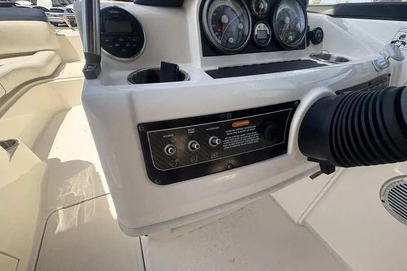 Slide: The Image of 2016 Bayliner 215 Deck Boat dashboard with controls and gauges. - 27