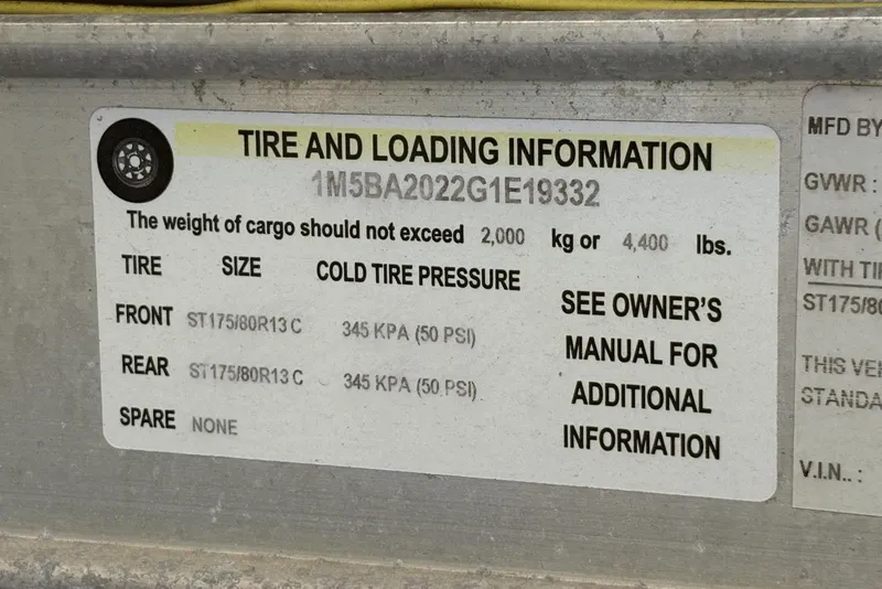 Slide: The Image of Tire and loading information label for 2016 Bayliner 215 Deck Boat, showing pressure and weight limits. - 28