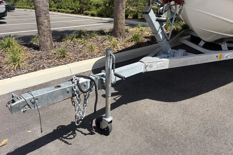 Slide: The Image of Trailer hitch of a 2016 Bayliner 215 Deck Boat in a parking lot. - 30