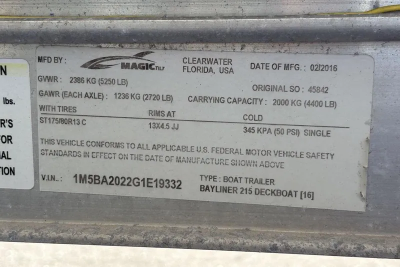 Slide: The Image of Label on 2016 Bayliner 215 Deck Boat trailer, detailing specifications and safety standards. - 31