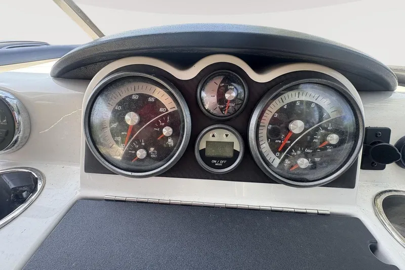 Slide: The Image of Dashboard of a 2016 Bayliner 215 Deck Boat with gauges and controls. - 6