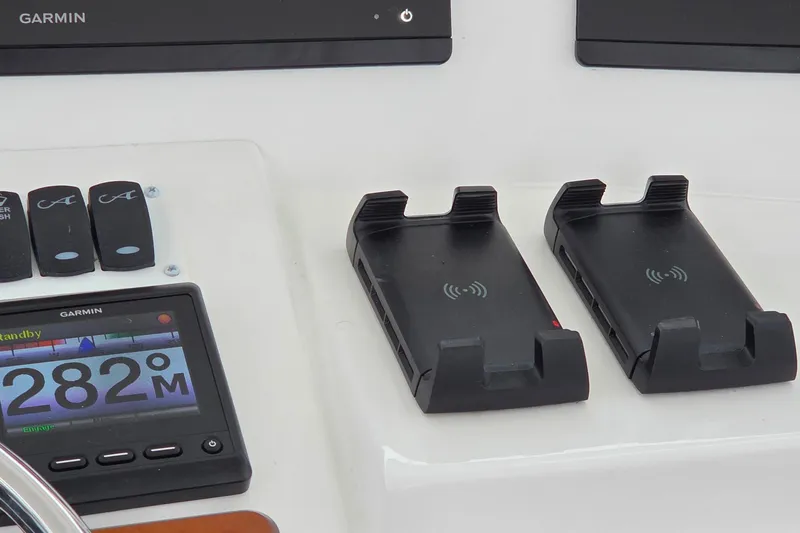 Slide: The Image of 2022 Albemarle 36 Express helm with modern navigation displays and white seating. - 12