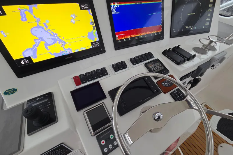 Slide: The Image of Control panel of 2022 Albemarle 36 Express with Garmin display and wireless charging docks. - 14