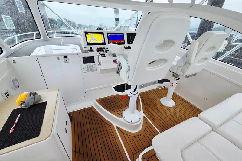Slide: The Image of Control panel of 2022 Albemarle 36 Express boat with navigation screens and steering wheel. - 16