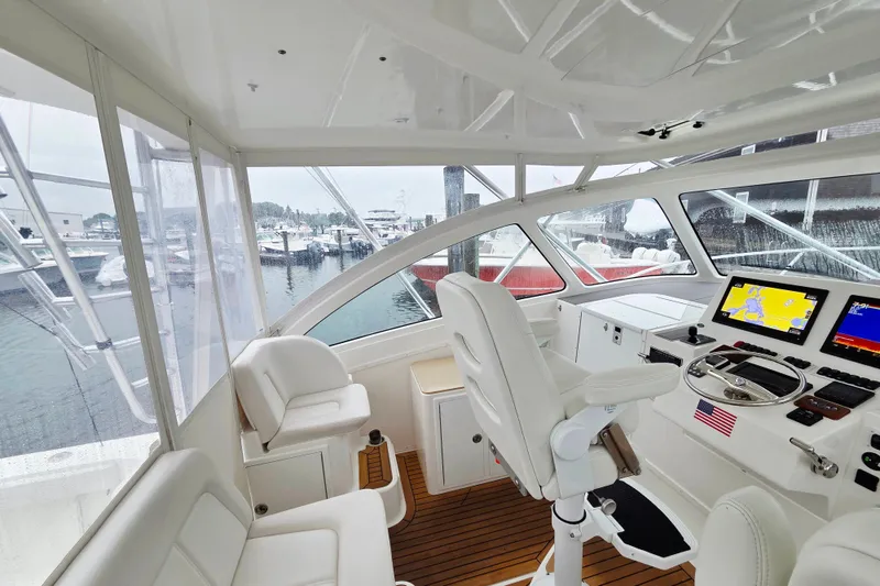 Slide: The Image of 2022 Albemarle 36 Express helm with modern navigation displays and comfortable seating. - 17