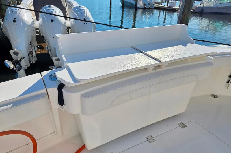 Slide: The Image of 2022 Albemarle 36 Express boat cockpit with polished wood table and cup holders. - 26