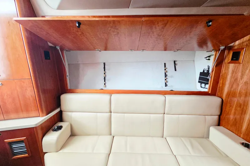 Slide: The Image of Luxurious interior of 2022 Albemarle 36 Express yacht with wood finish and cozy seating. - 32