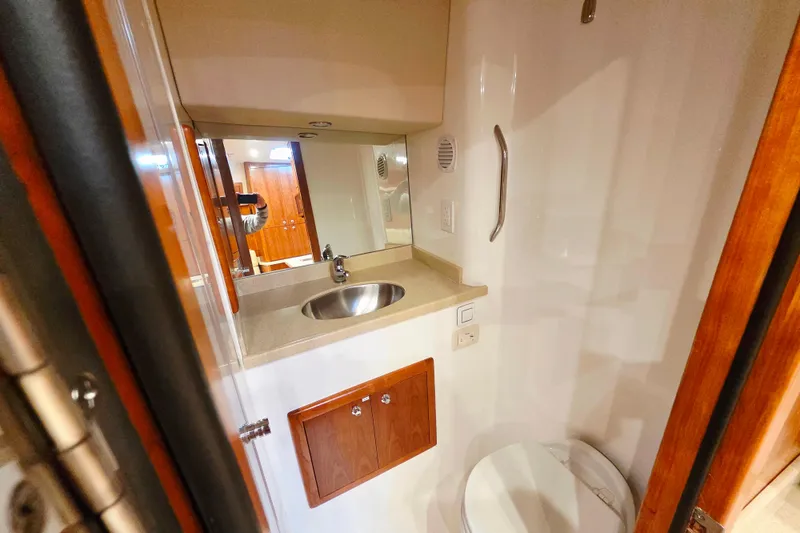 Slide: The Image of 2022 Albemarle 36 Express interior with beige seating and wooden cabinetry. - 34