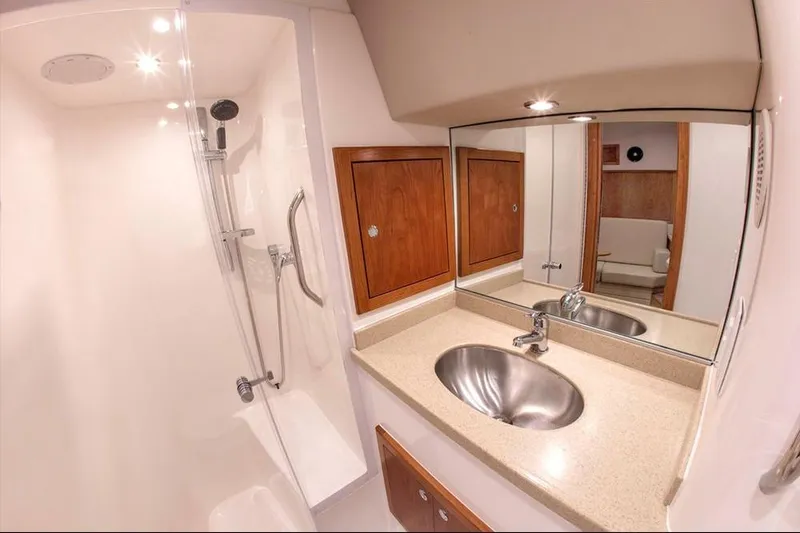 Slide: The Image of 2022 Albemarle 36 Express interior with rod storage and wooden accents. - 35