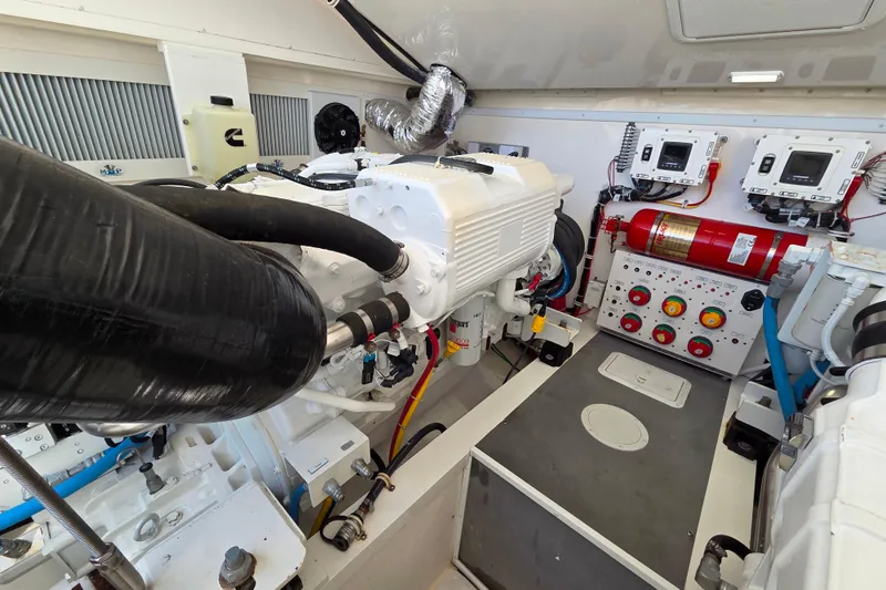 Slide: The Image of Engine room of 2022 Albemarle 36 Express boat, featuring dual engines and control systems. - 38
