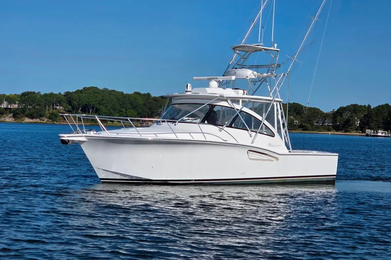 Slide: The Image of 2022 Albemarle 36 Express boat on calm water, surrounded by lush greenery. - 4