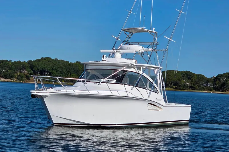 Slide: The Image of 2022 Albemarle 36 Express boat on calm water with lush green trees in the background. - 5