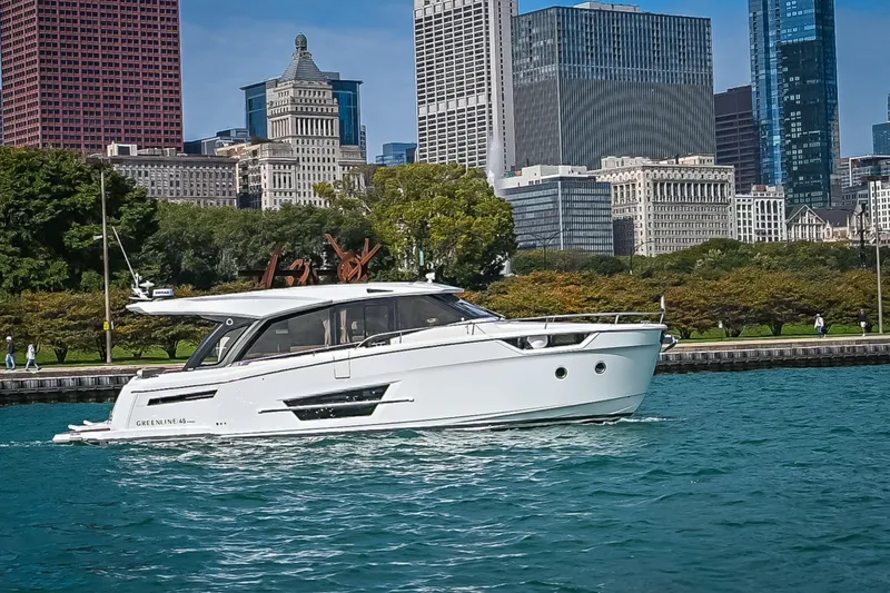 Slide: The Image of 2024 Greenline 45 Coupe Hybrid yacht cruising near urban skyline. - 1