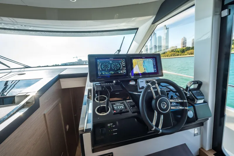Slide: The Image of 2024 Greenline 45 Coupe Hybrid yacht cockpit with advanced navigation displays. - 10