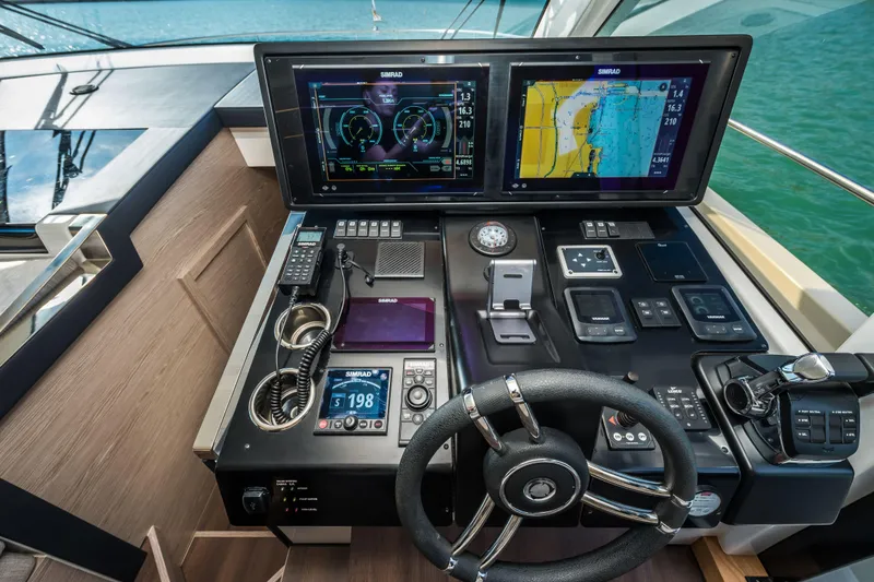 Slide: The Image of 2024 Greenline 45 Coupe Hybrid yacht cockpit with advanced navigation displays and controls. - 11