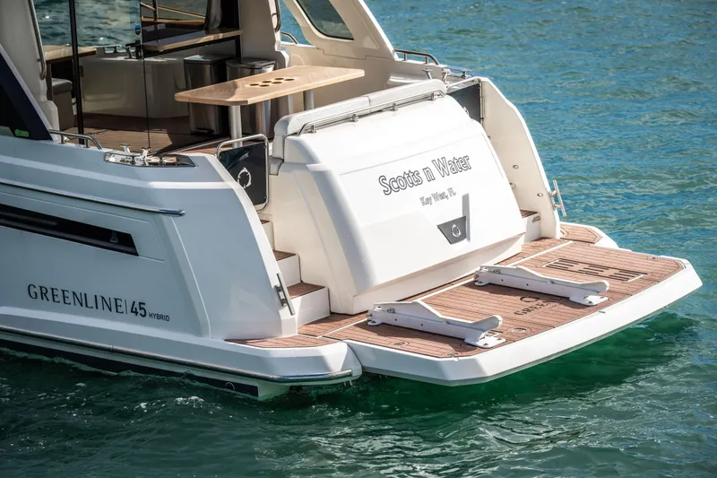 Slide: The Image of 2024 Greenline 45 Coupe Hybrid yacht on water, rear view with open deck. - 21