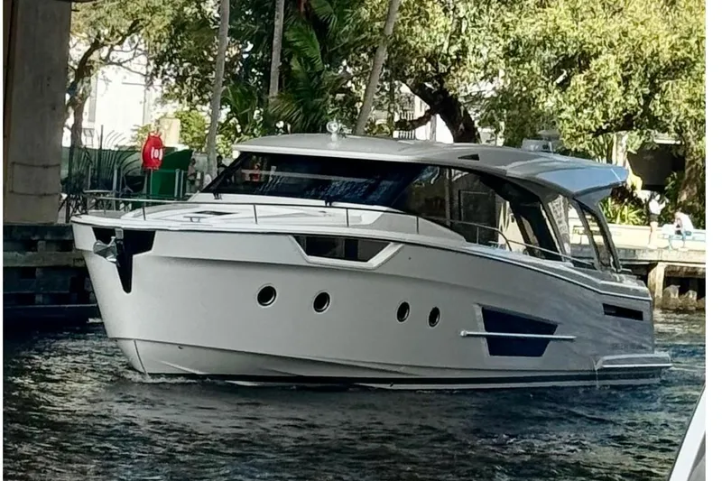 Slide: The Image of 2024 Greenline 45 Coupe Hybrid yacht cruising on a scenic waterway. - 27