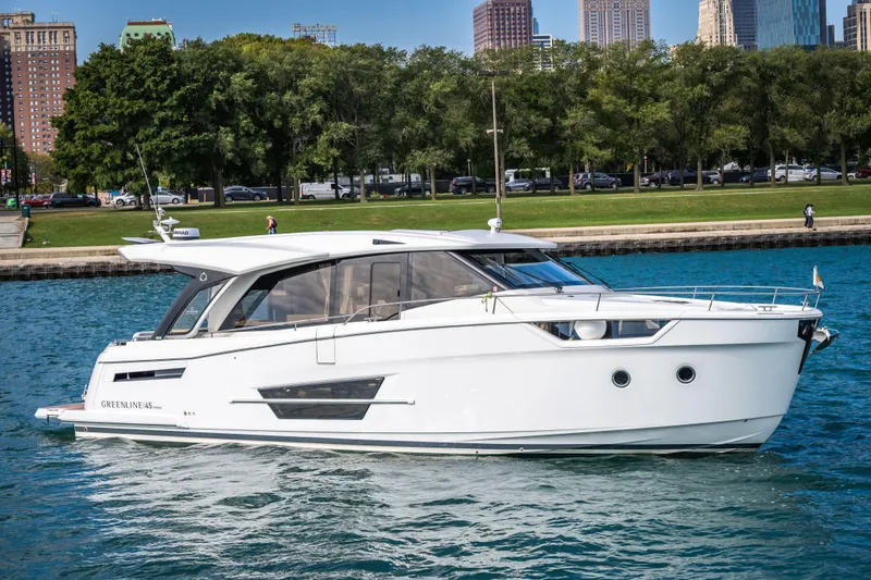 Slide: The Image of 2024 Greenline 45 Coupe Hybrid yacht cruising on a scenic waterfront. - 28