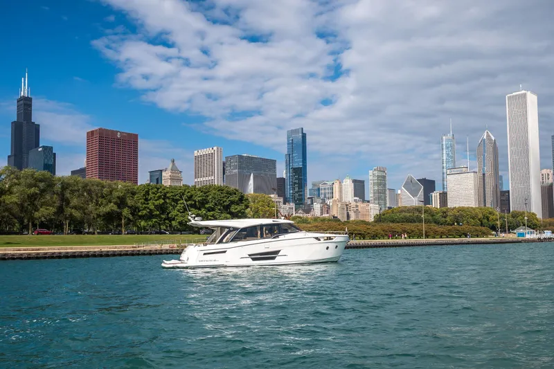 Slide: The Image of 2024 Greenline 45 Coupe Hybrid yacht cruising near city skyline. - 3