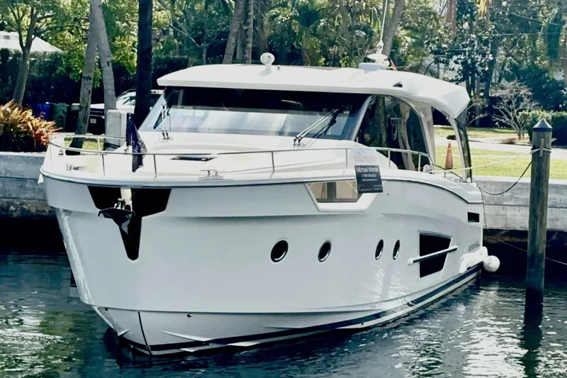 Slide: The Image of 2024 Greenline 45 Coupe Hybrid yacht docked in a serene marina setting. - 30