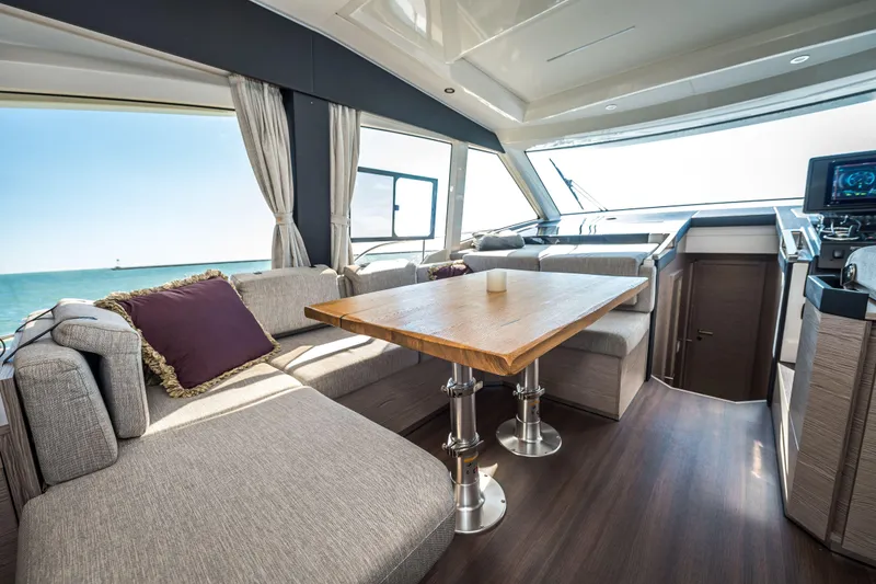 Slide: The Image of Luxurious interior of 2024 Greenline 45 Coupe Hybrid yacht with elegant seating and ocean view. - 5