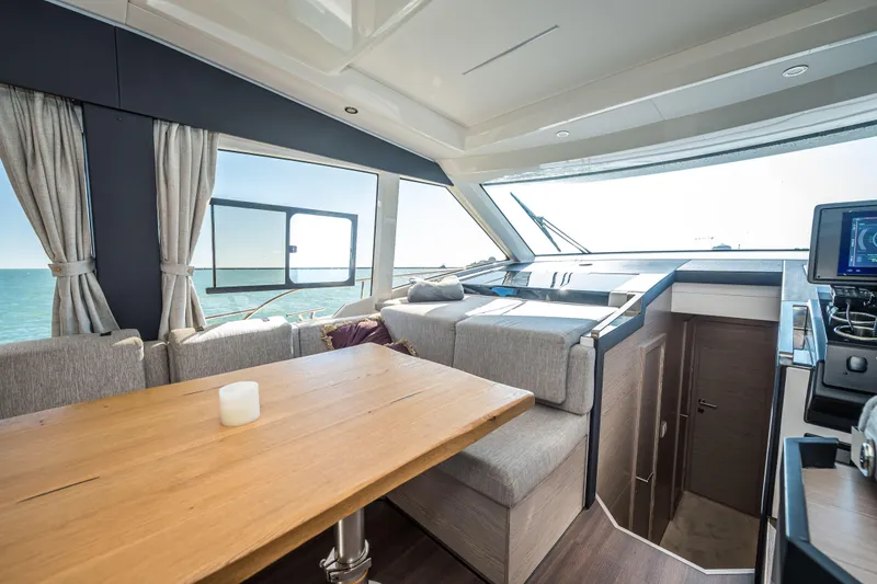 Slide: The Image of Interior of 2024 Greenline 45 Coupe Hybrid yacht with modern seating and ocean view. - 6