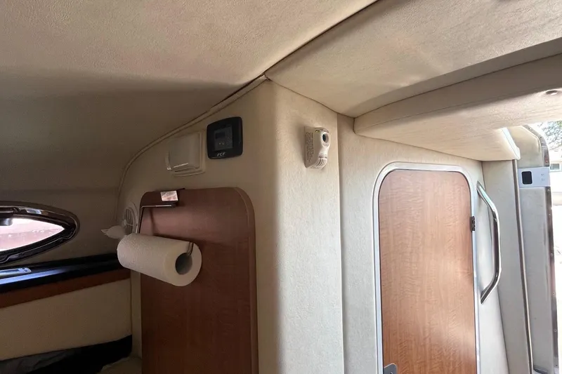 Slide: The Image of Interior of 2006 Sea Ray 260 Sundancer boat with wooden door and paper towel holder. - 11