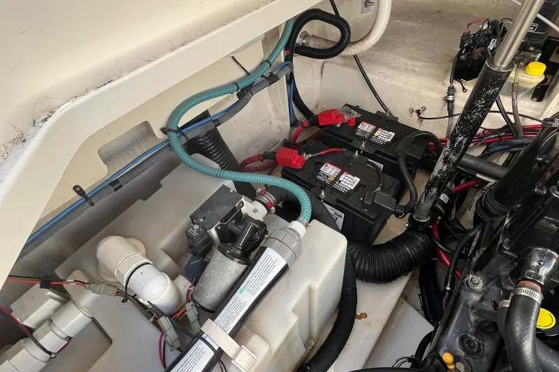 Slide: The Image of Engine compartment of a 2006 Sea Ray 260 Sundancer with batteries and wiring. - 16