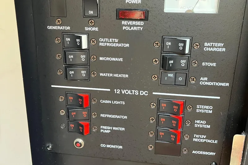 Slide: The Image of Electrical control panel on a 2006 Sea Ray 260 Sundancer boat, featuring various switches. - 18