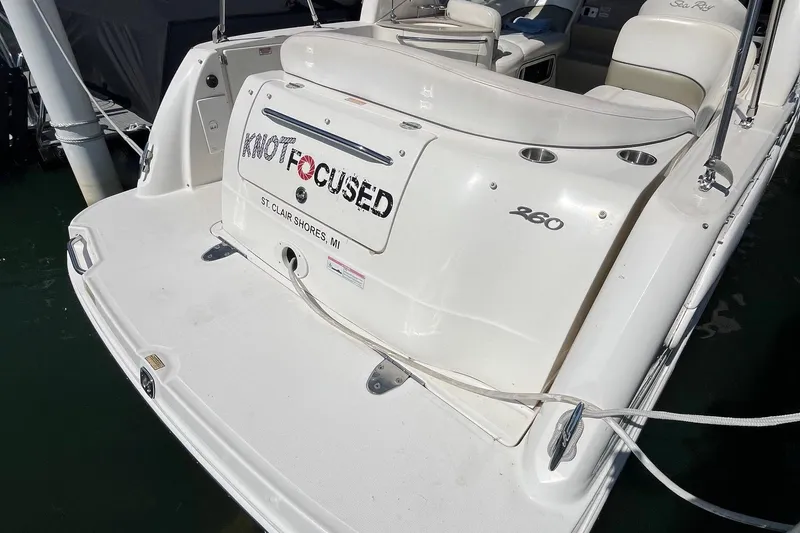 Slide: The Image of 2006 Sea Ray 260 Sundancer boat docked, featuring "Knot Focused" nameplate. - 4