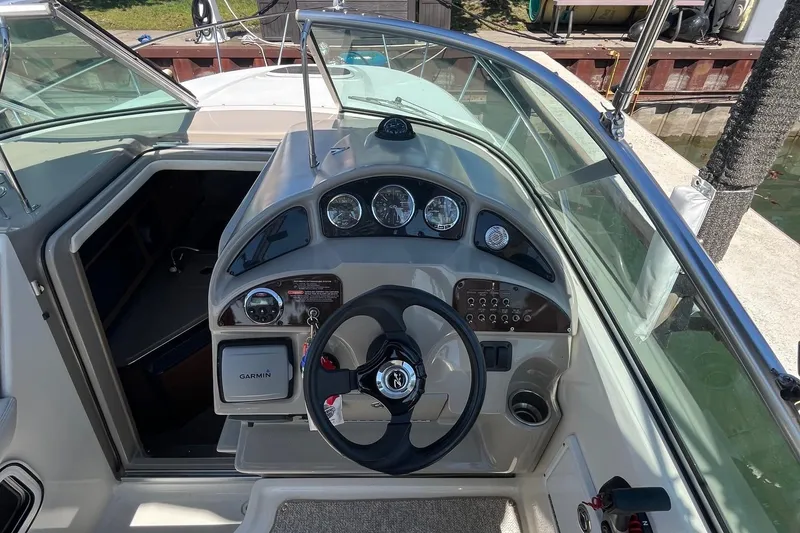 Slide: The Image of 2006 Sea Ray 260 Sundancer boat dashboard with steering wheel and gauges. - 5