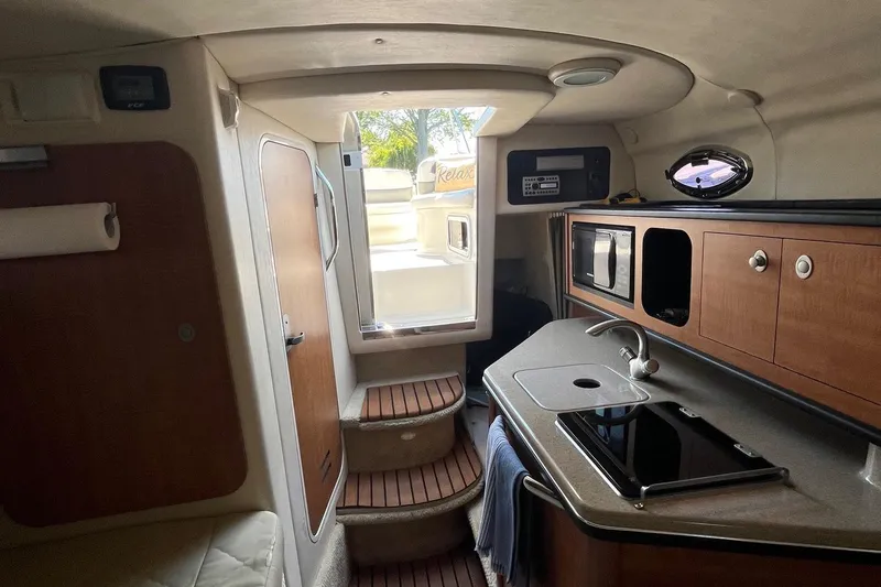 Slide: The Image of Interior of 2006 Sea Ray 260 Sundancer boat with kitchenette and stairs. - 9