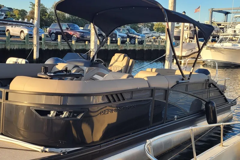 The Image of 2024 Bennington 24LXSSB pontoon boat docked, featuring sleek design and comfortable seating. - 0
