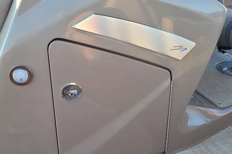 Slide: The Image of 2024 Bennington 24LXSSB boat interior detail with storage compartment and speaker. - 16