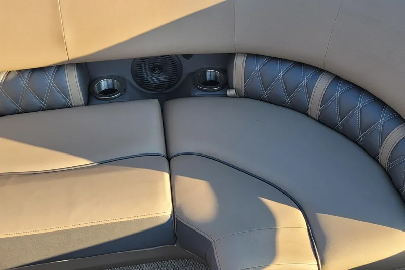 Slide: The Image of Luxurious seating on 2024 Bennington 24LXSSB boat with cup holders and speaker. - 22