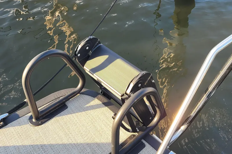 Slide: The Image of 2024 Bennington 24LXSSB boat ladder and deck by the water. - 29