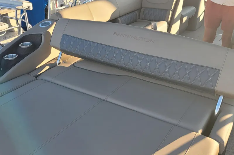 Slide: The Image of 2024 Bennington 24LXSSB boat interior with luxurious seating and cup holders. - 32