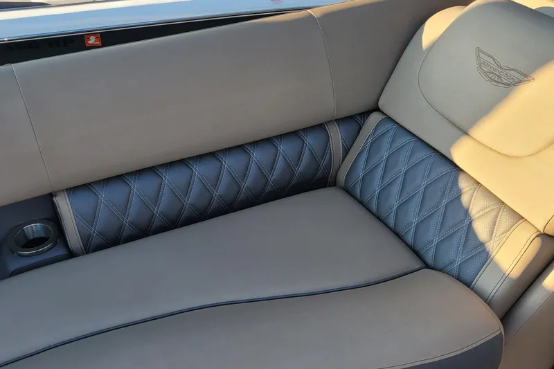 Slide: The Image of 2024 Bennington 24LXSSB boat interior with luxurious quilted seating and cup holder. - 33