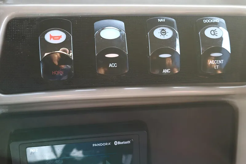 Slide: The Image of Control panel of 2024 Bennington 24LXSSB boat with horn, navigation, and lighting switches. - 41