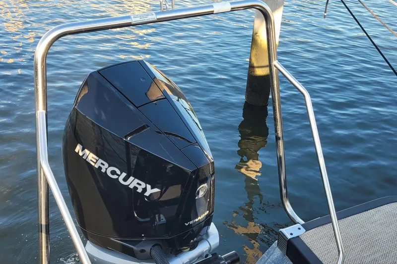 Slide: The Image of 2024 Bennington 24LXSSB with Mercury outboard engine on water. - 43