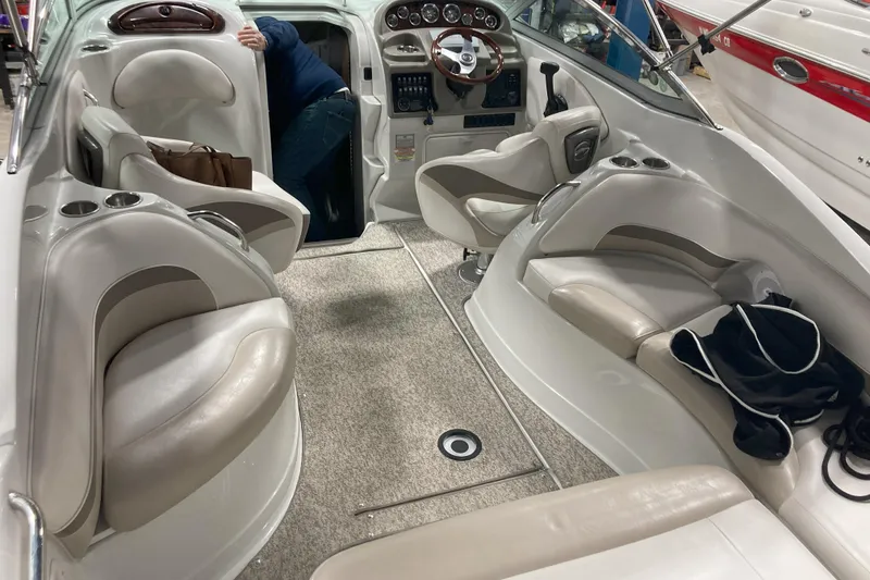 Slide: The Image of 2011 Crownline 286 SC boat interior with beige seating and steering wheel. - 3