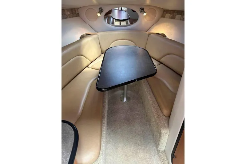 Slide: The Image of Interior of 2011 Crownline 286 SC boat with beige seating and table. - 7