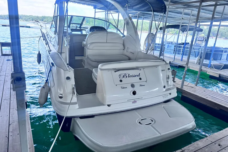 Slide: The Image of 2005 Sea Ray 300 Sundancer docked, featuring spacious seating and elegant design. - 1