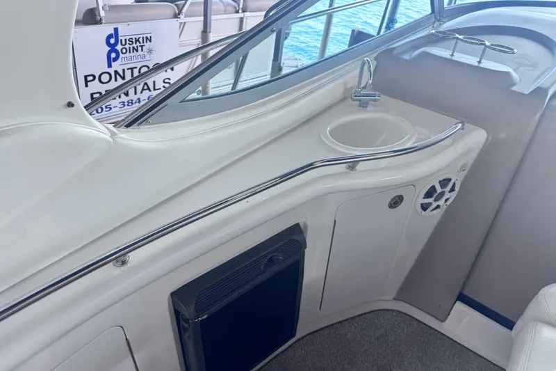 Slide: The Image of 2005 Sea Ray 300 Sundancer boat interior with sink and storage area. - 10