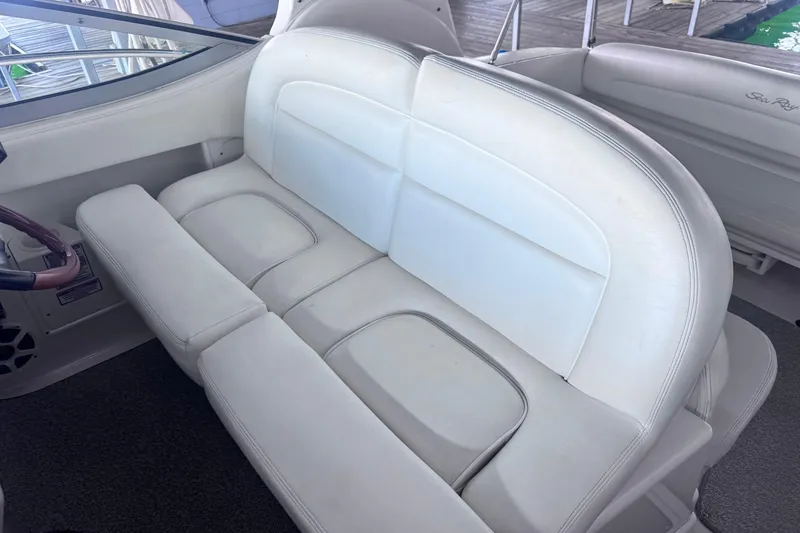 Slide: The Image of White leather seating on a 2005 Sea Ray 300 Sundancer boat. - 11