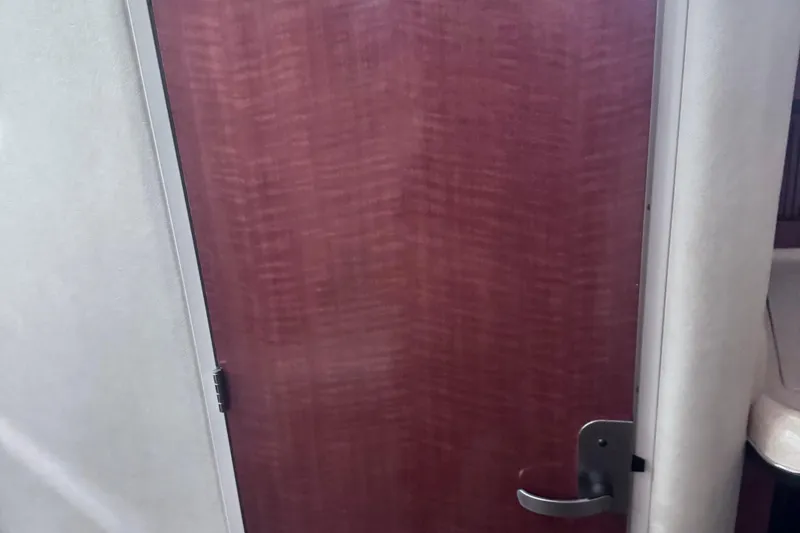 Slide: The Image of Wooden cabin door on a 2005 Sea Ray 300 Sundancer boat interior. - 15