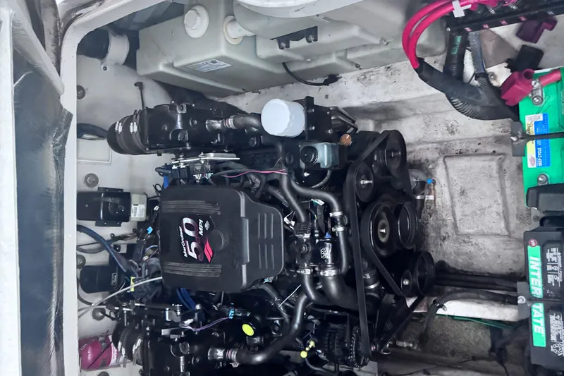 Slide: The Image of Engine compartment of a 2005 Sea Ray 300 Sundancer boat, featuring a MerCruiser 5.0 MPI engine. - 19