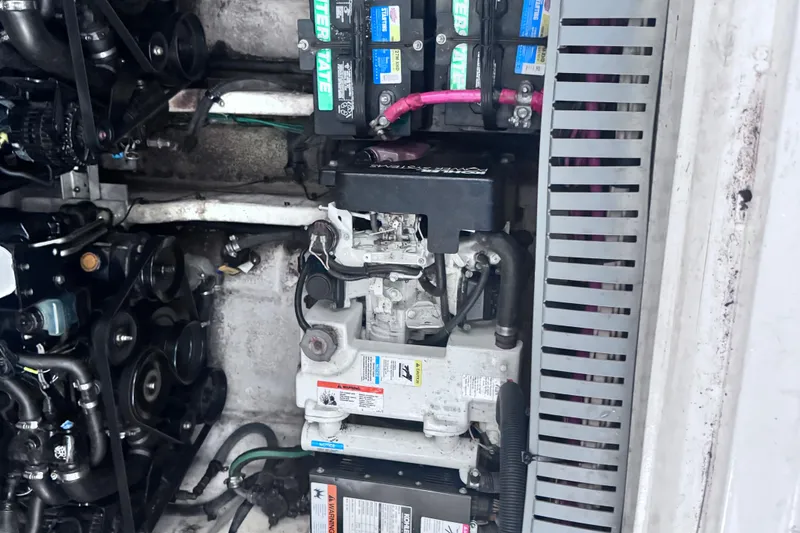 Slide: The Image of Engine compartment of a 2005 Sea Ray 300 Sundancer with visible batteries and components. - 20