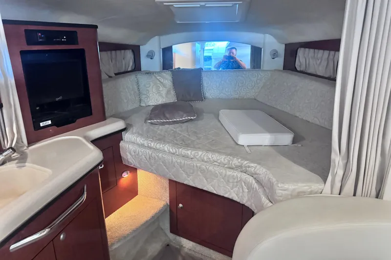 Slide: The Image of Interior of 2005 Sea Ray 300 Sundancer with cozy bed and entertainment area. - 21