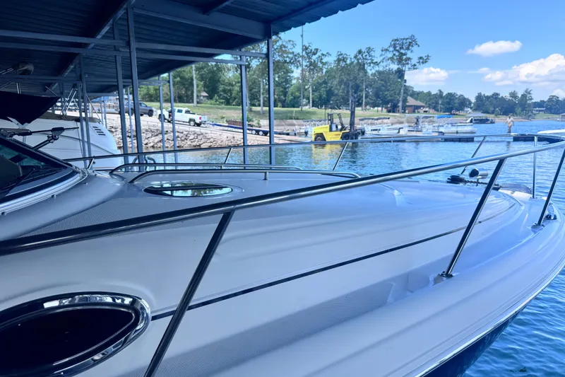 Slide: The Image of 2005 Sea Ray 300 Sundancer docked at a marina under a blue sky. - 25